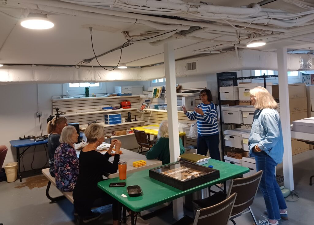 Myrna Crook talking to club members about artifact analysis and cataloging