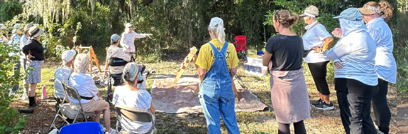 Club members preparing for the dig with Janis Rodriguez presenting an overview