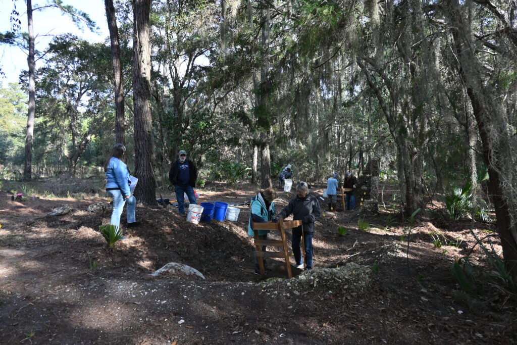 Volunteer crew screening for artifacts and documenting each bucket load